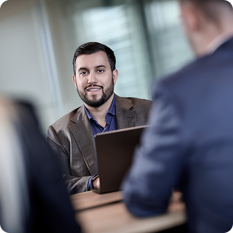 Marcello Genovese at modern office desk in business casual attire