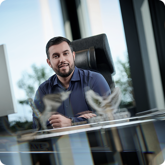 Marcello Genovese professional headshot smiling in blue shirt